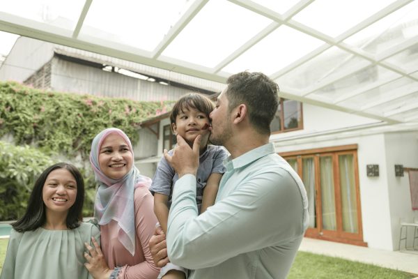 Happy family celebrating during party. They are enjoying at back yard.